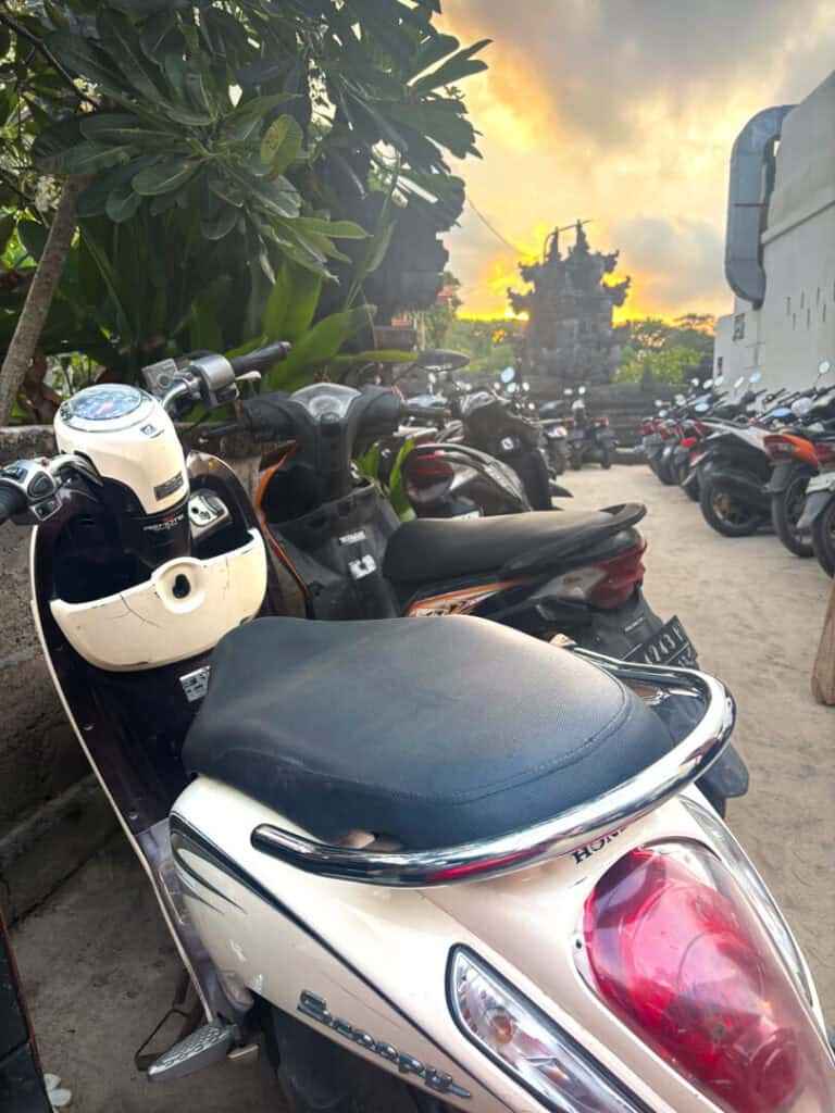 Scooters parked along the street in Nusa Lembongan during sunset