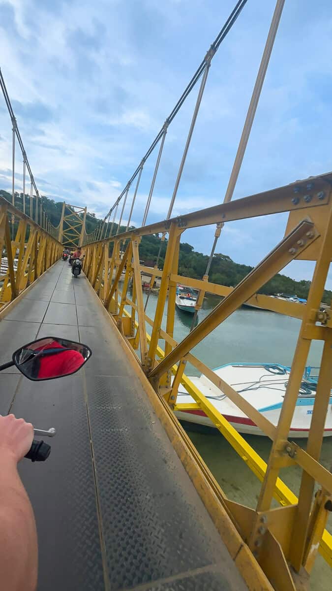 Crossing the narrow Yellow Bridge on Nusa Lembongan by scooter