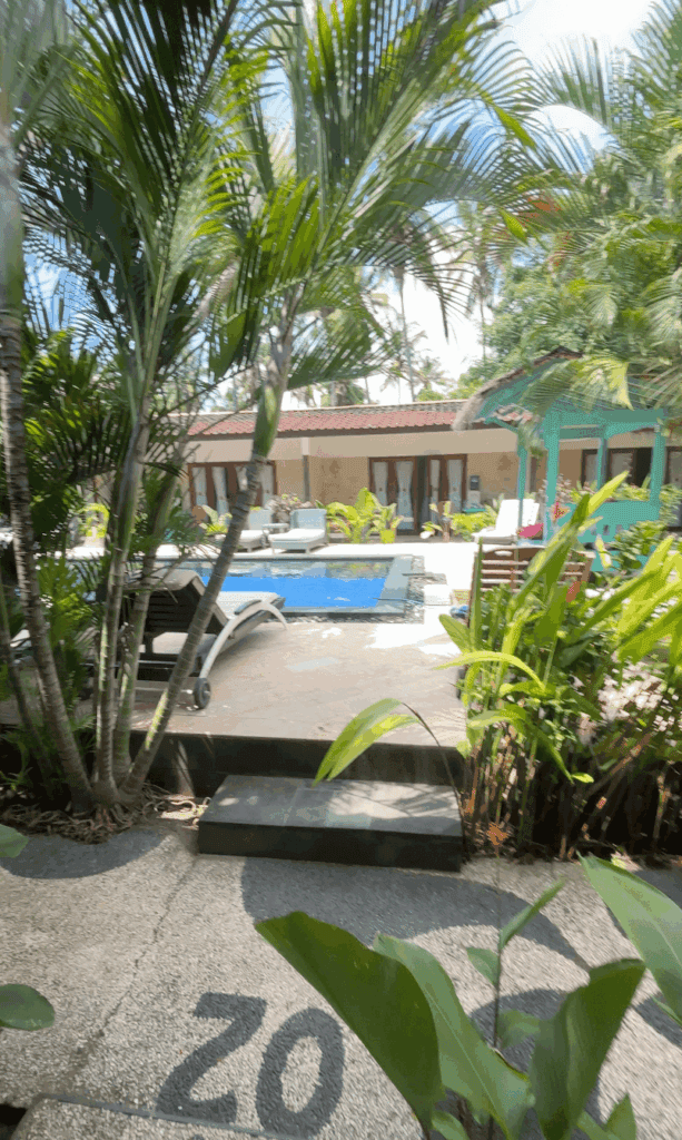 Hotel room patio in Bali with access and view of the pool