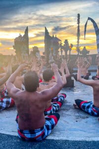 The Uluwatu Kecak Dance begins as 50-100 men take the stage while chanting