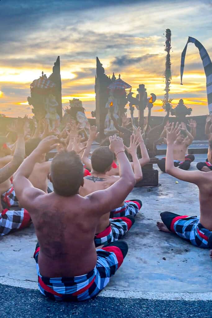 The Uluwatu Kecak Dance begins as 50-100 men take the stage while chanting
