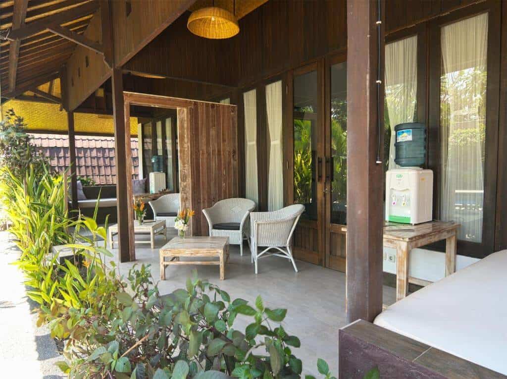 Spacious front patio at Gili Air Bungalows includes a day bed and small dining set up