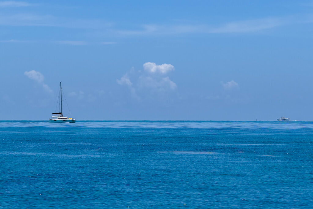 Sailboat crossing bright blue water off the coast of Key West.