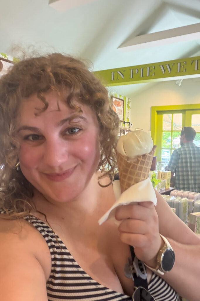 Woman holding a key lime ice cream cone inside Kermit’s Key Lime Shoppe in Key West