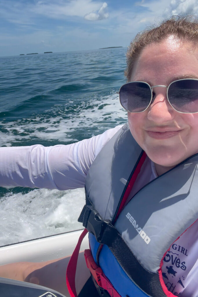 Jet ski rider wearing a life vest and sun shirt while riding on the water in Key West.