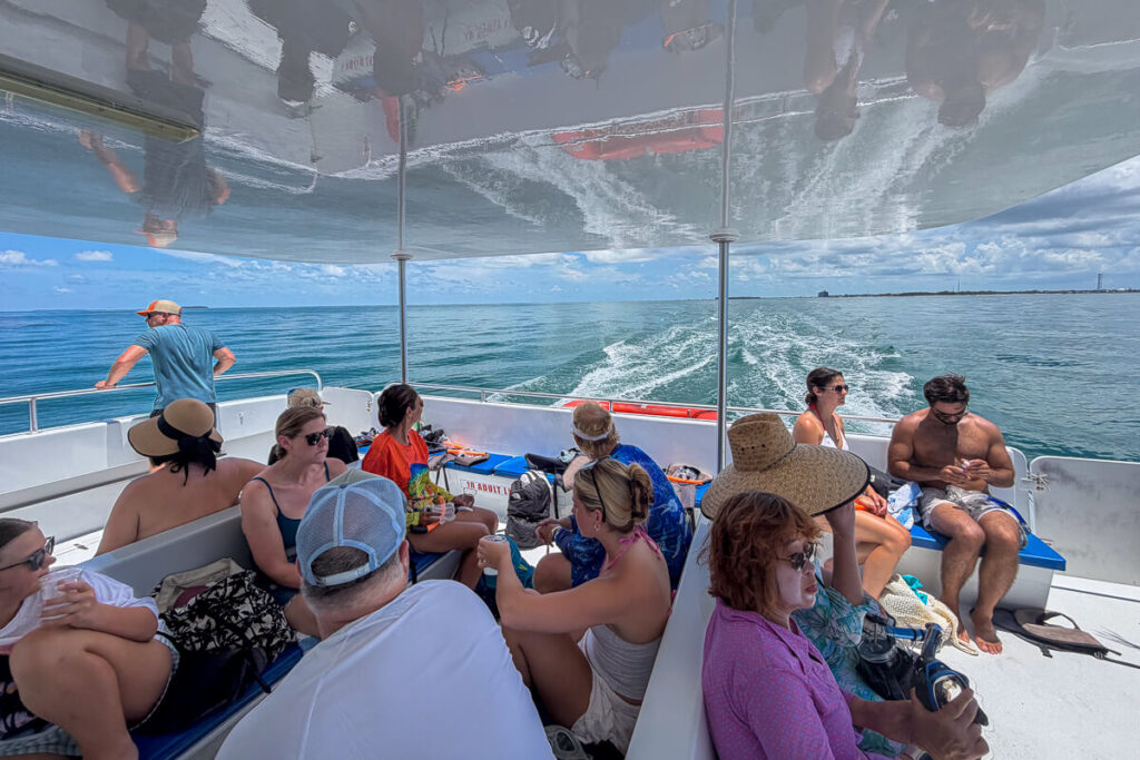Guests sitting beneath the covered seating area aboard a Fury snorkeling boat in Key West.
