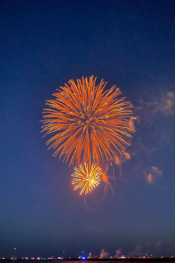 Fireworks bursting over the water at dusk during a Fourth of July celebration in Key West.